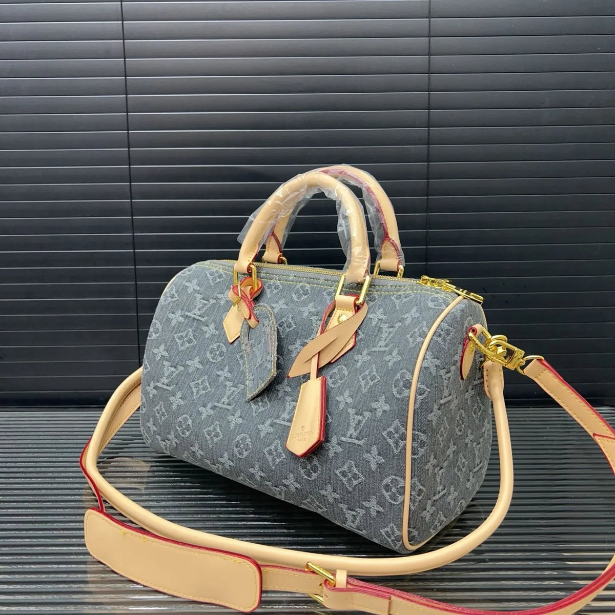 Denim parçanın və monoqram naxışın detalı, yaxın plan